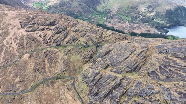 Drone view of a camper van approaching the Top Of The Healey Pass epic road trip in Cork Kerry on The Wild Atlantic Way in summer