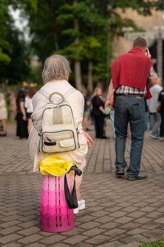 Festival visitors resting and walking through a crowded outdoor event area