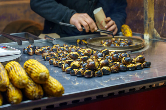 Freshly roasted chestnuts on a street food stall