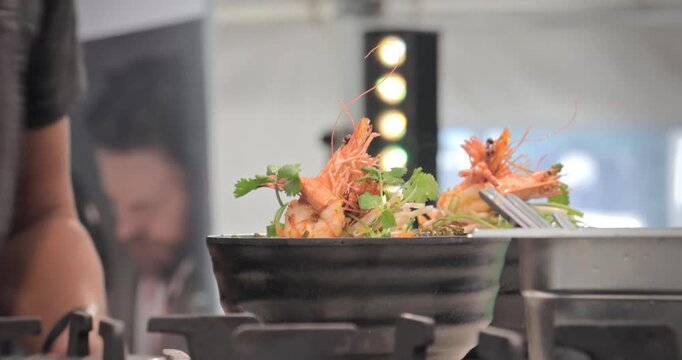 Chef cooking food dish in professional kitchen