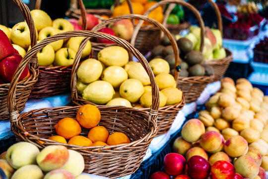 Assortment of fresh fruits in wicker baskets at a farmers market