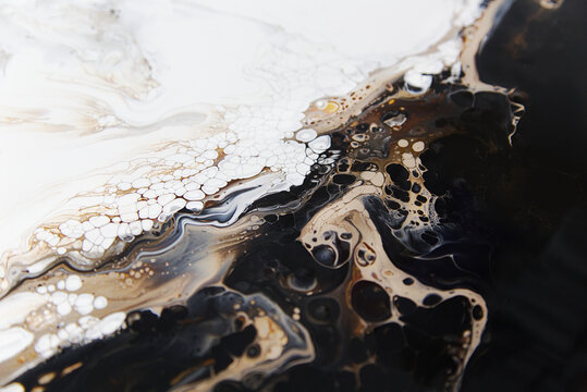 Acrylic pour fluid abstract artwork on canvas, showing flowing paint patterns in neutral color palette.