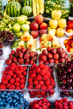 Fresh fruits and berries on display at a vibrant farmers market