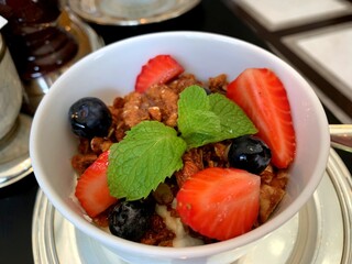 Macro shot of healthy yogurt bowl with granola and fresh fruits. © Nika.style