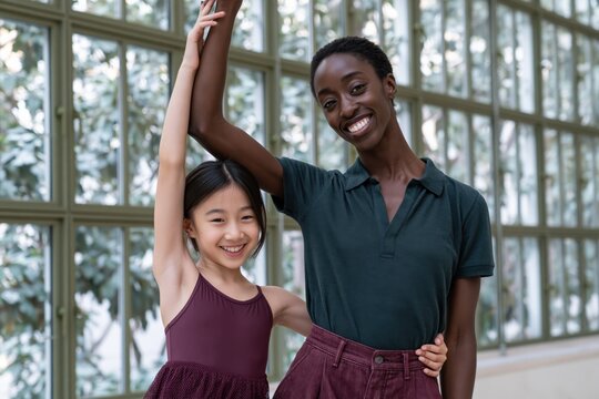 Diverse ballet teacher and young student smiling in a bright studio for dance class poster and educational banner