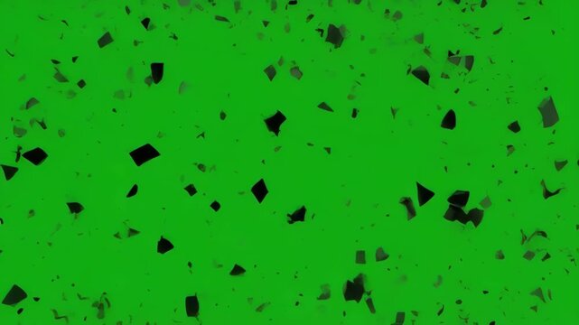 Dark particles expanding in concentric rings against a green screen background
