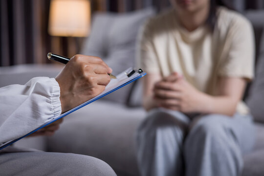 Compassionate caregiver monitoring depression symptoms and writing daily notes, mental health support, counseling, recovery, patient care, psychology, emotional wellness, trust.