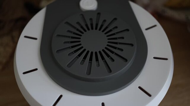 Close up hand turns on food dehydrator preparing appliance to dry fruits vegetables and homemade snacks for healthy food preservation and everyday kitchen use