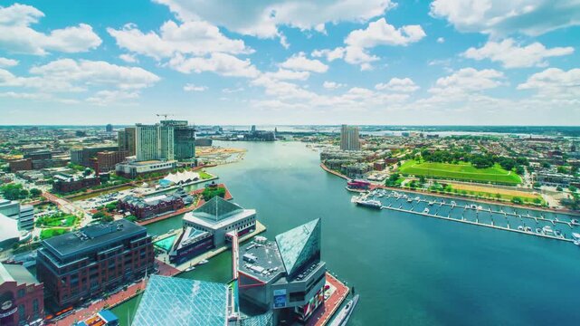 Baltimore Inner Harbor Aerial View Timelapse Featuring Modern Skyscrapers and Bustling Waterfront Boat Traffic on a Sunny Summer Day Captured in High Resolution 4k Video