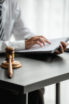 Business attorney works on legal consult with judge gavel