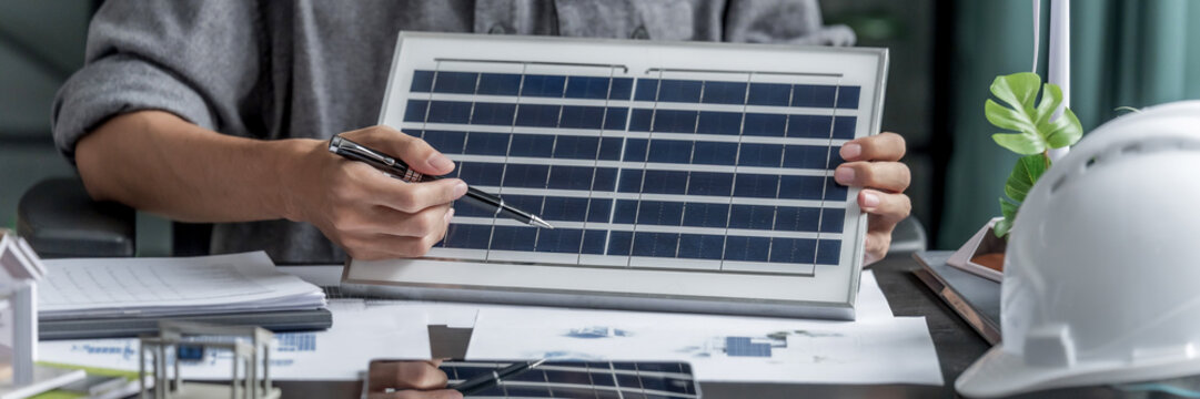 Business man designs green electricity plans in eco friendly office environment
