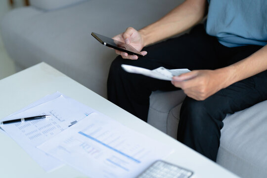 male calculating personal financial for future plan at his home, taxes payment