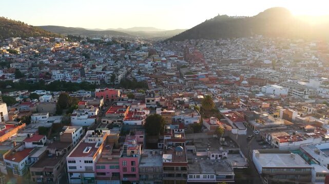 A sweeping aerial vista capturing the sunrise illumination across the expansive urban landscape of Pachuca de Soto.