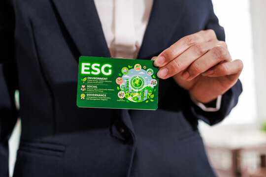 Business person holding a green esg card about environment, social and governance, sustainability and responsible company values.