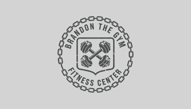 Gym fitness center vintage badge design featuring crossed dumbbells in a shield surrounded by a strong metal chain.