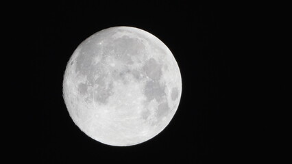 Moon astronomy space capturing a detailed view of the lunar surface with craters and highlights against the pitch black night sky © svetograph