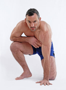 MMA fighter on combat position isolated on white background.