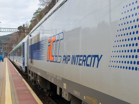 Szklarska Poreba, Poland - December 21, 2025: PKP Intercity train carriage sits at a station platform, reflecting modern rail travel infrastructure for passenger journeys