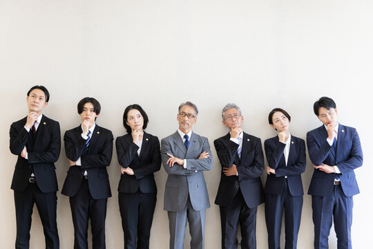 考え込む7人の日本人弁護士チームの集合ポートレート