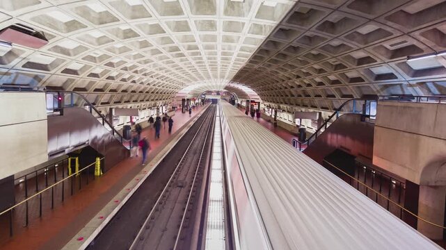 Subway Station Interior with Commuters Moving on Platforms 4k Timelapse Shot of Concrete Vaulted Ceilings and Underground Rail Lines in a Modern Metropolitan Transit Hub