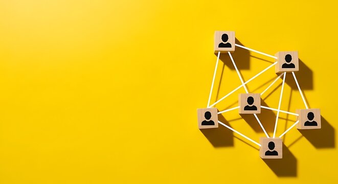 Wooden blocks with person icons linked by white lines against yellow backdrop, concept of networking