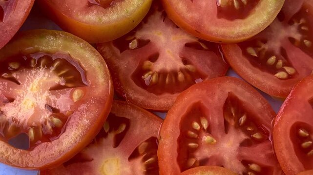 sliced tomato on a wooden board