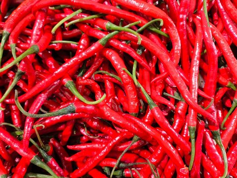 Bright red chili peppers fill the frame