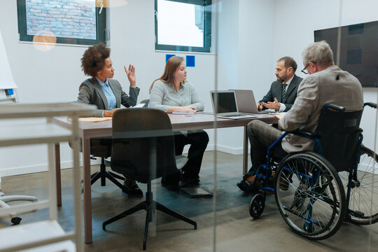 Diverse business professionals meeting in modern office