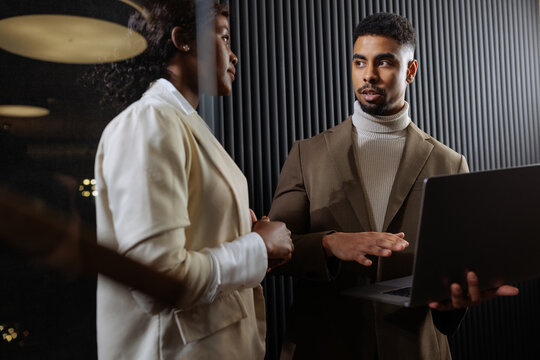 Business colleagues collaborating on project with laptop
