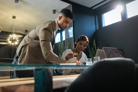 Business professionals collaborating at office meeting with coffee