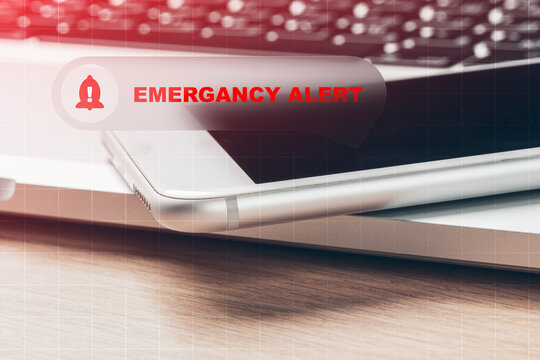 Emergency alert notification with digital devices in a workspace setting during daytime