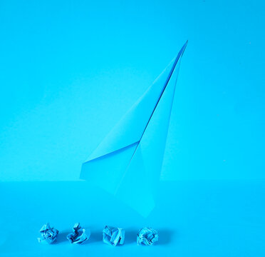 Innovation for business transformation and success, brainstorming concept with crumpled paper balls and a paper plane taking off