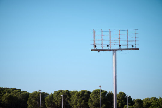 Large empty billboard with post and blue sky.