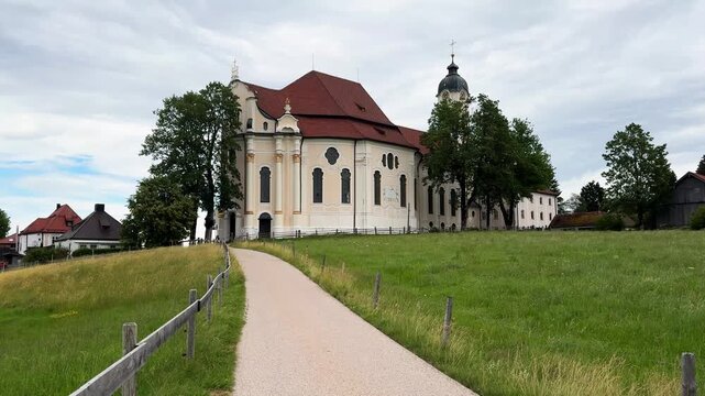 STEINGADEN, BAVARIA, GERMANY - 07.06.2026: Exterior view of the Pilgrimage Church of Wies, a famous Rococo style church and UNESCO World Heritage site located in a rural meadow.