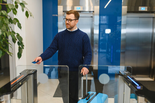 Man scanning access card at office turnstile