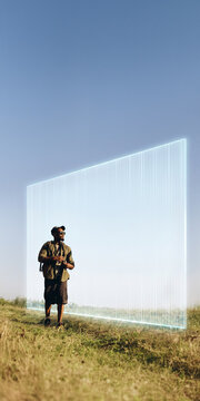 Solo backpacker standing before wide translucent portal on hillside. Concept of choice and future direction for travel campaigns, career messaging and inspirational advertising.