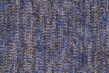 Close-up of blue and gray knitted fabric texture with detailed woven pattern, suitable as a textile background or abstract material surface. © eza