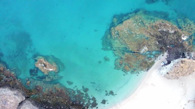 Drone's aerial top down view of turquoise sea and rocky Los Muertos Beach in Cabo de Gata, Almeria, Spain