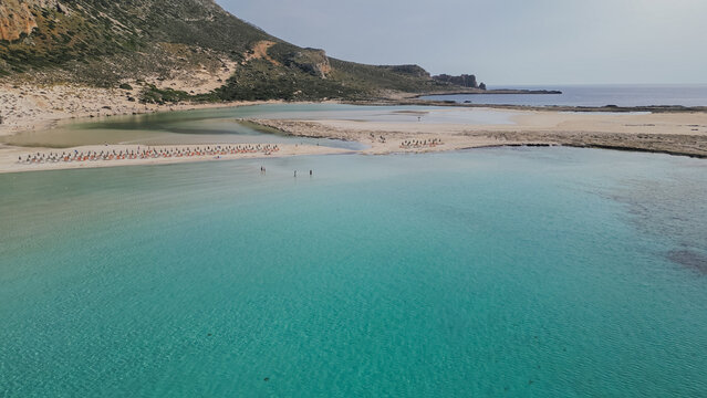 Aerial view of turquoise Balos lagoon beach with shallow clear water and sand bar in Chania region Crete island Greece on a sunny bright summer day