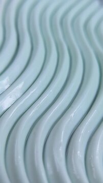 Close up of beauty cream featuring an elegant wave pattern. Self care product concept, smooth texture for daily skincare routine.