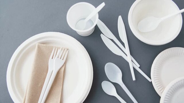 Top down view of eco friendly disposable tableware and compostable cutlery.
