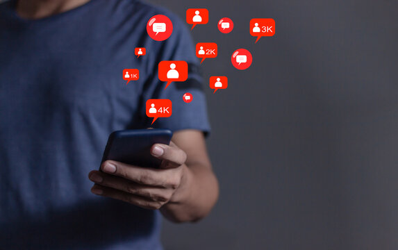 Love And Comment Social Media Concept, Young Man hand using smart phone mobile, with Social Media, on soft blurred background