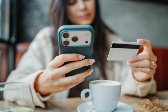 Woman shopping online with mobile phone and credit card