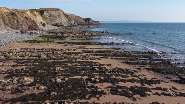 Tide coming in at rocky Sandymouth Bay in Cornwall UK