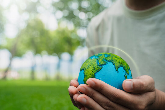 A crystal globe placed on moss. ESG concept (Environment, Society, and Governance). Sustainable global environment concept. Ecology. Conservation. Environmental concepts. Green business.