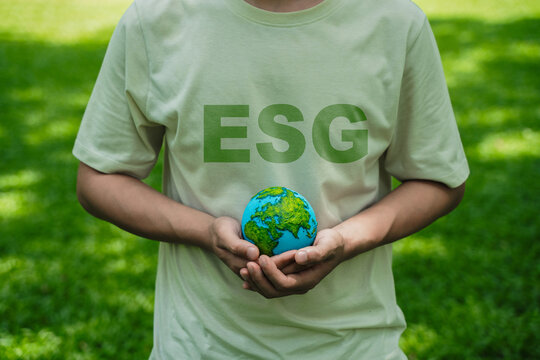 A crystal globe placed on moss. ESG concept (Environment, Society, and Governance). Sustainable global environment concept. Ecology. Conservation. Environmental concepts. Green business.