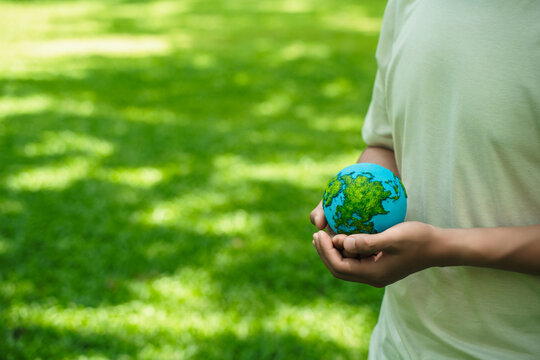 A crystal globe placed on moss. ESG concept (Environment, Society, and Governance). Sustainable global environment concept. Ecology. Conservation. Environmental concepts. Green business.