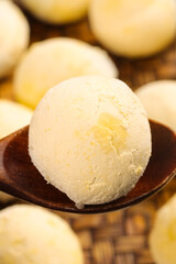 Fototapeta premium Handmade Asian Dumplings with Sesame Seeds on Wooden Spoon - Traditional Chinese Steamed Buns