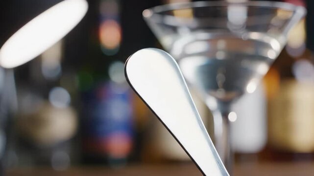 Blank Stainless Steel Cocktail Garnish Pick Against Blurred Bar Background with Martini Glass