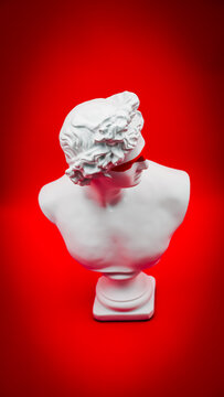 Contemporary Classical White Greek Bust with Red Painted Eyes on a Vibrant Red Background